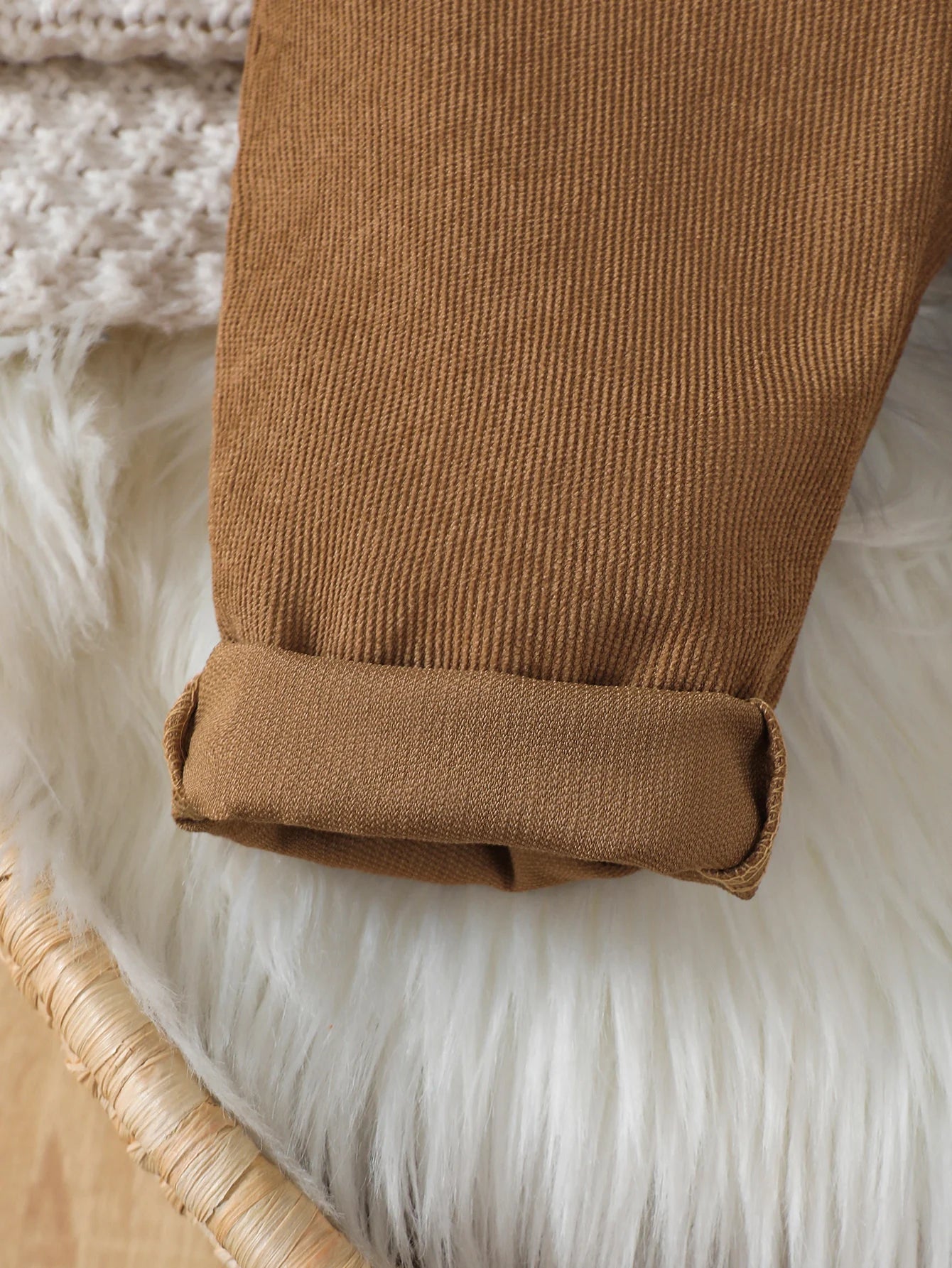 Side or lifestyle view of boys corduroy bear pattern bib overalls
