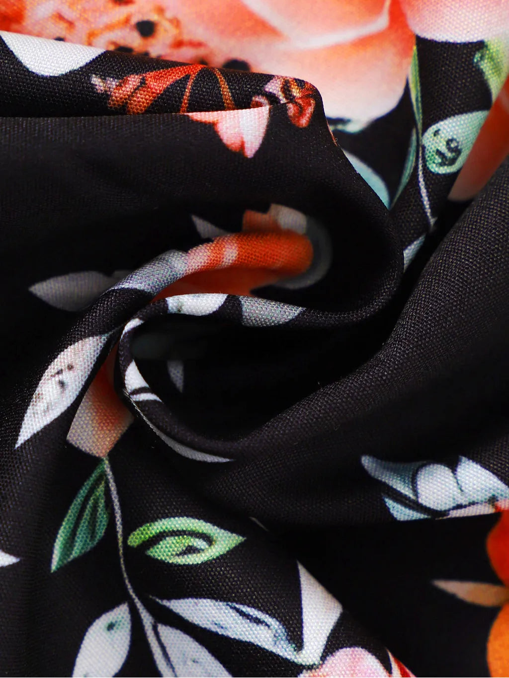Baby girl wearing a sleeveless floral party dress with a bow