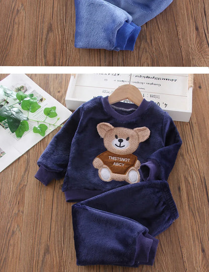 Close up highlighting the hem and stitching on the kids flannel fleece cartoon bear pyjama set