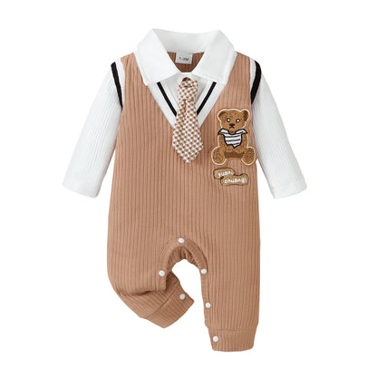Baby boy wearing a smart short-sleeve romper with an attached tie