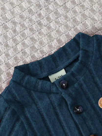 Fabric and texture detail of baby boys red bear badge onesie & hat set