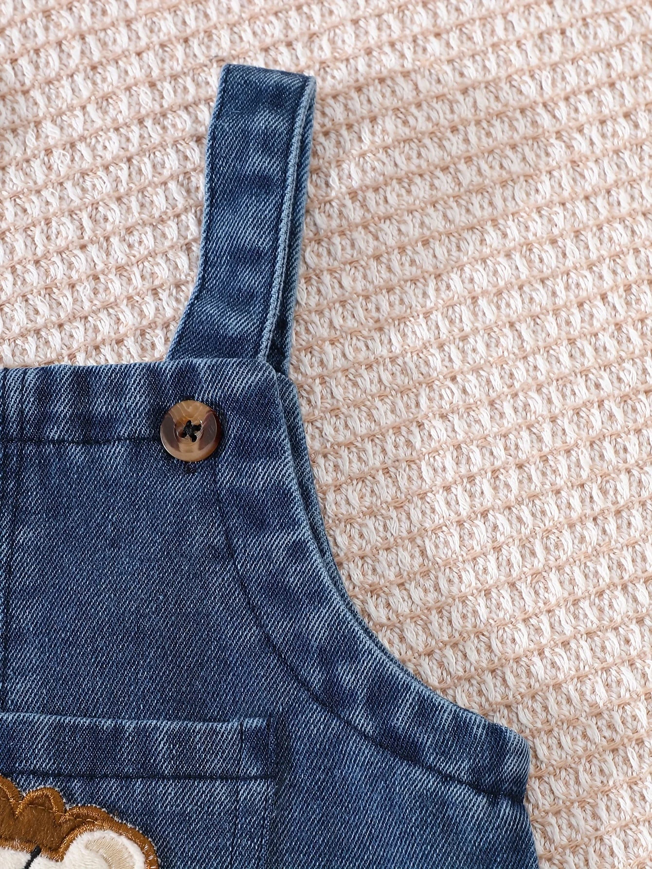 Side or lifestyle view of baby boys short sleeve top and lion overalls set