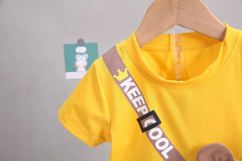 Focus on the neckline and sleeve features of the boys cartoon bear t-shirt and shorts set