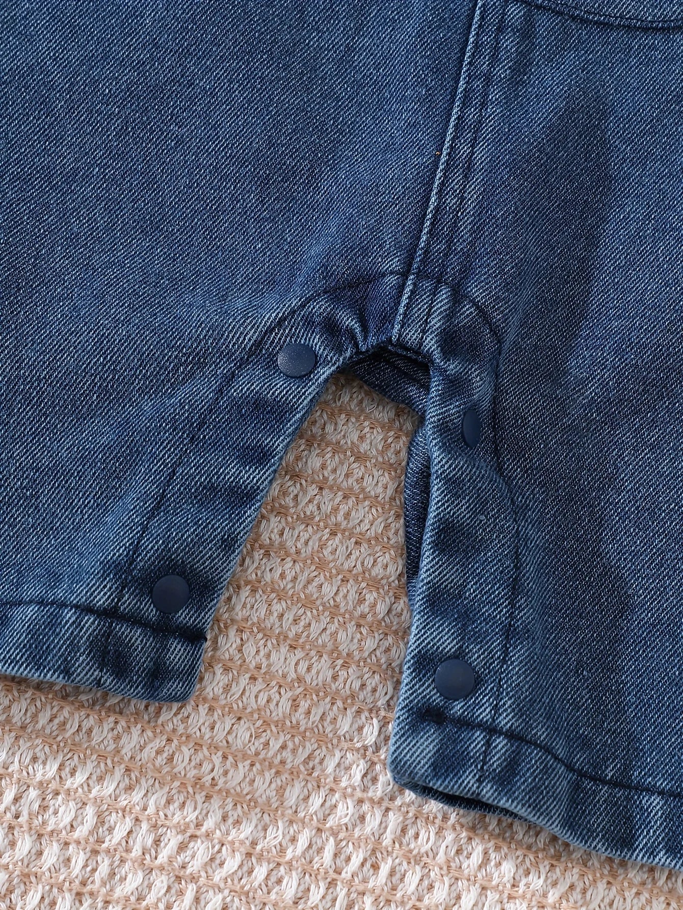 Close-up material detail of baby boys short sleeve top and lion overalls set