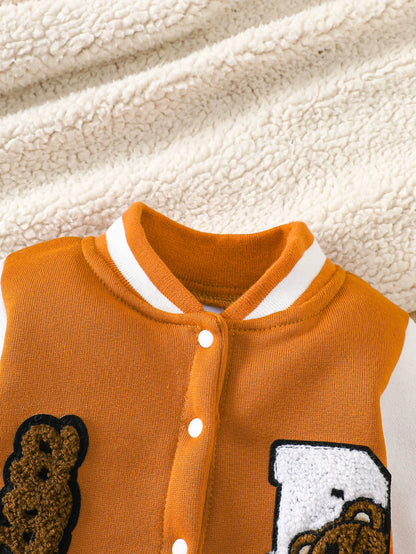 Baby boy wearing a caramel and orange fleece-lined baseball style romper