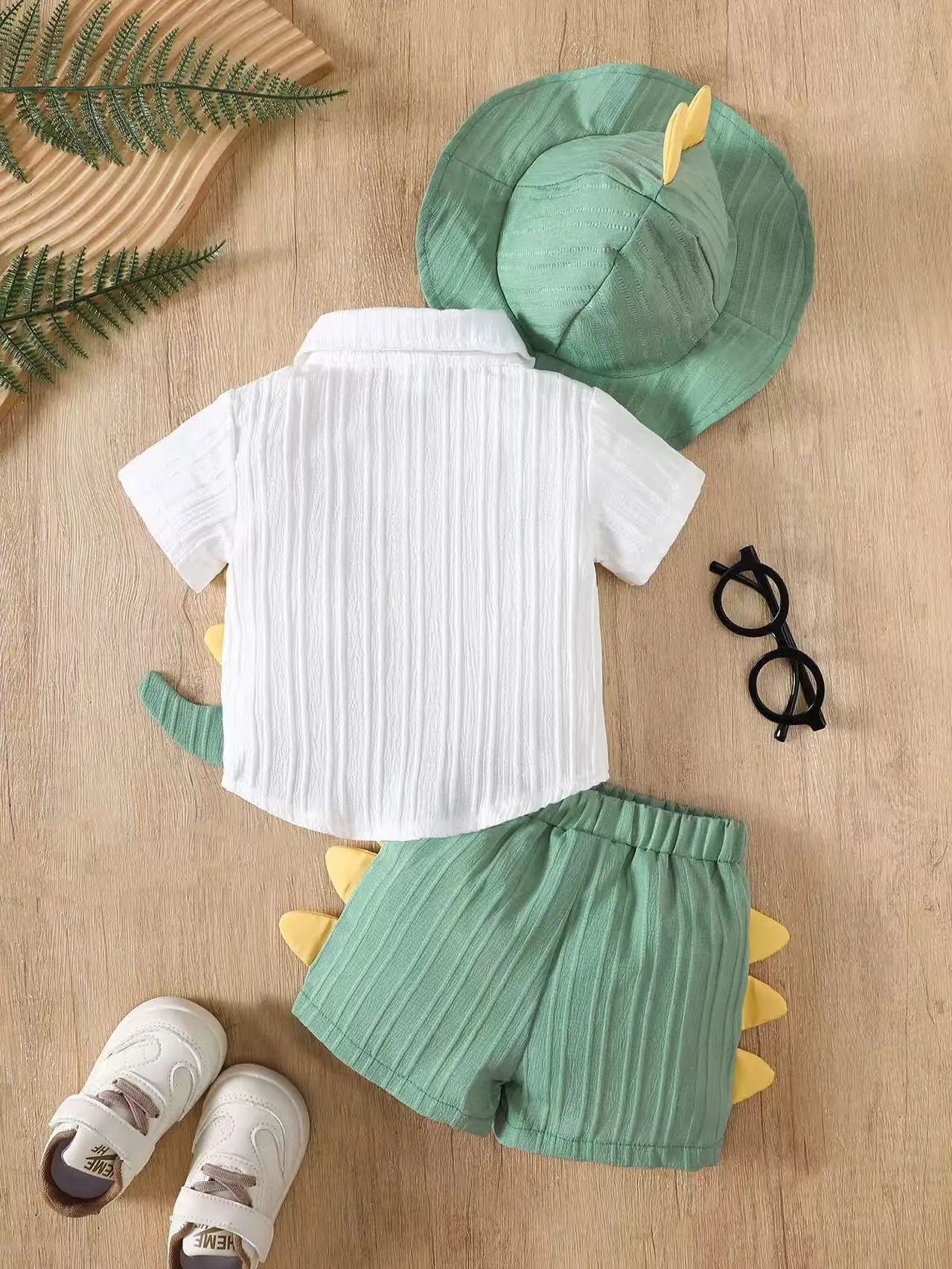 Side view of baby boys dinosaur summer outfit & sun hat