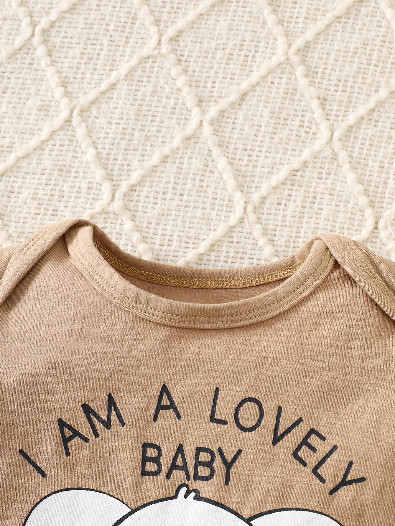 Styling option and alternate perspective of the baby boys elephant print romper four-piece set