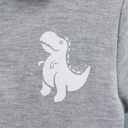 Baby boy wearing a dinosaur print t-shirt and matching shorts