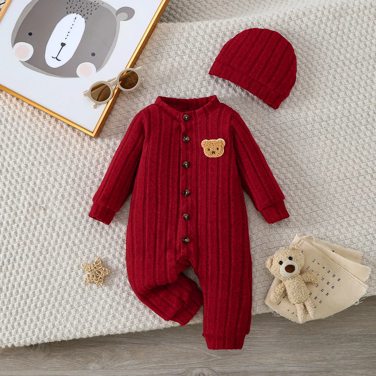 Red winter onesie with bear badge and matching hat