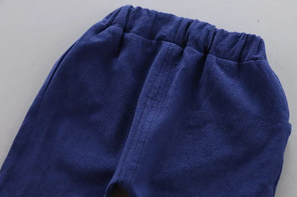 Close up highlighting the hem and stitching on the baby boys casual summer top and shorts set