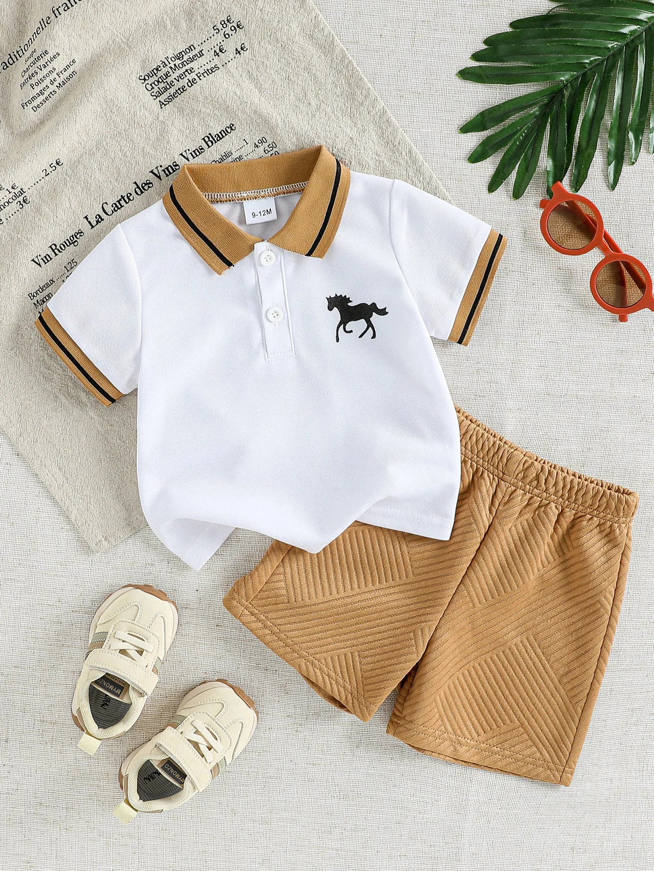 Focus on the neckline and sleeve features of the baby boys cartoon t-shirt and shorts summer set