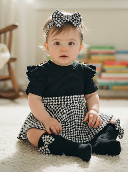 Side view of baby girls houndstooth romper dress set