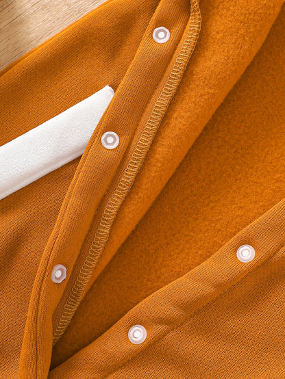 Baby boy wearing a caramel and orange fleece-lined baseball style romper