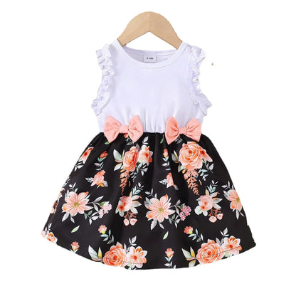 Baby girl wearing a sleeveless floral party dress with a bow
