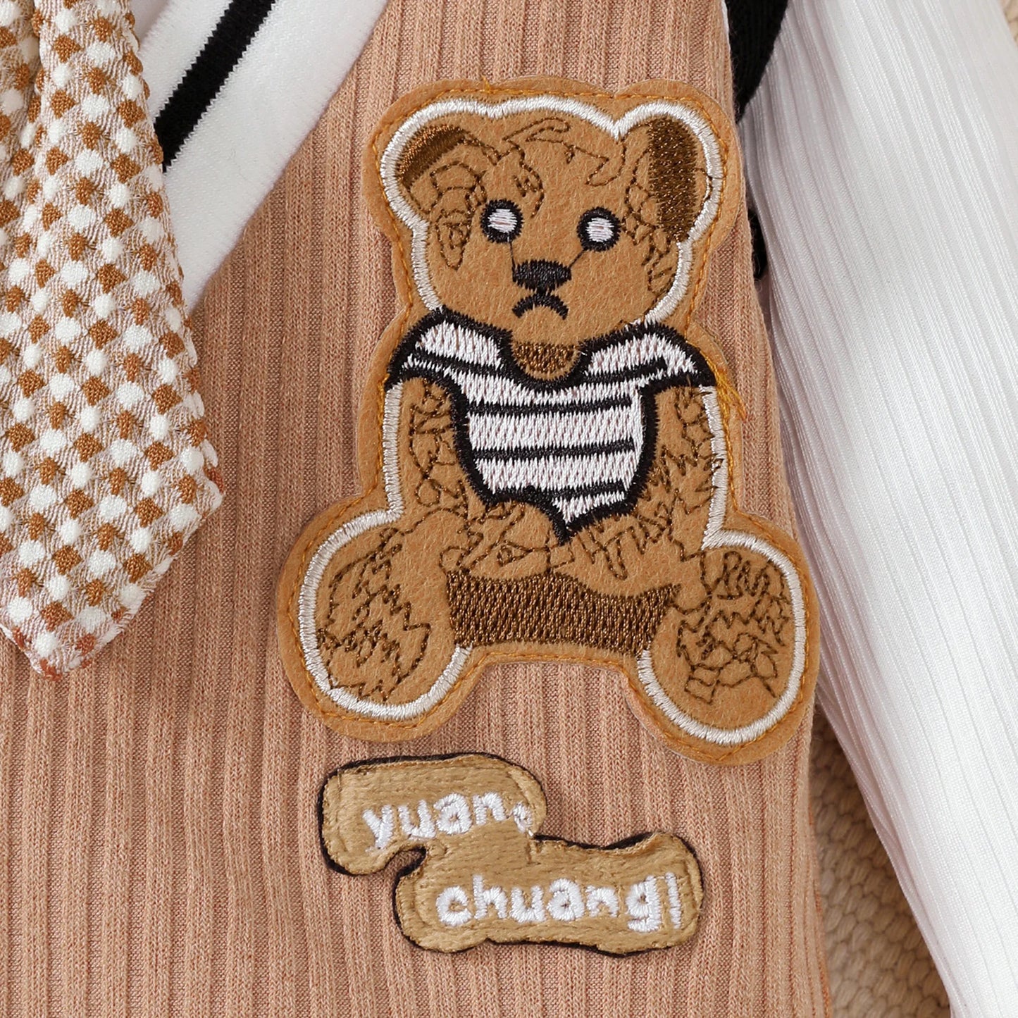 Baby boy wearing a smart short-sleeve romper with an attached tie
