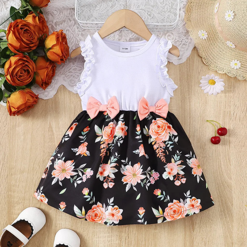 Baby girl wearing a sleeveless floral party dress with a bow