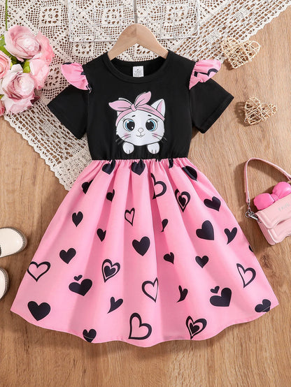 Girl wearing a mid-length dress with a cat and heart print and flutter sleeves