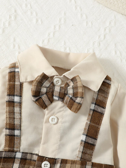 Close up highlighting the hem and stitching on the baby boys gentleman jumpsuit with suspenders and hat