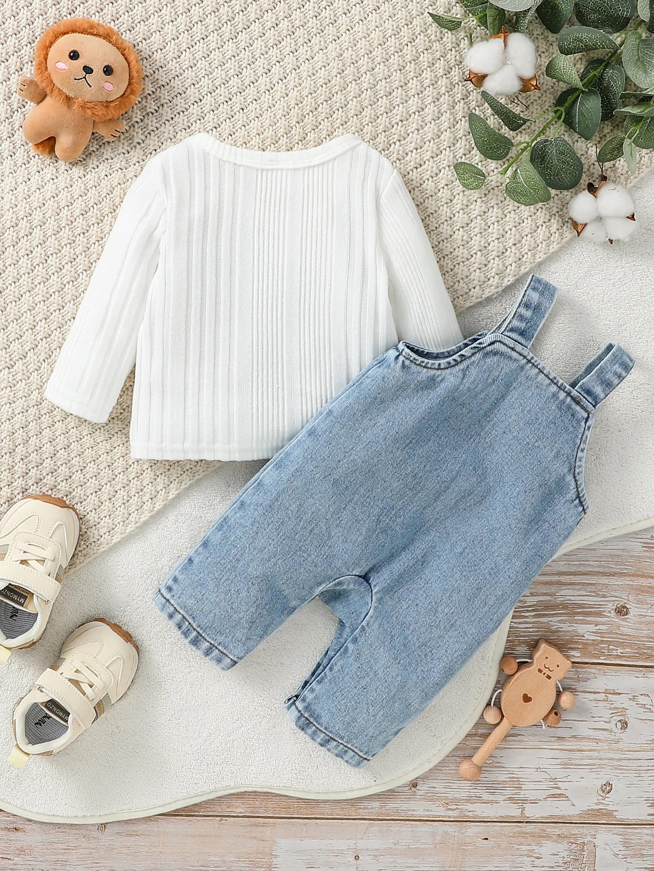 Side view of baby boys long sleeve romper top & trousers