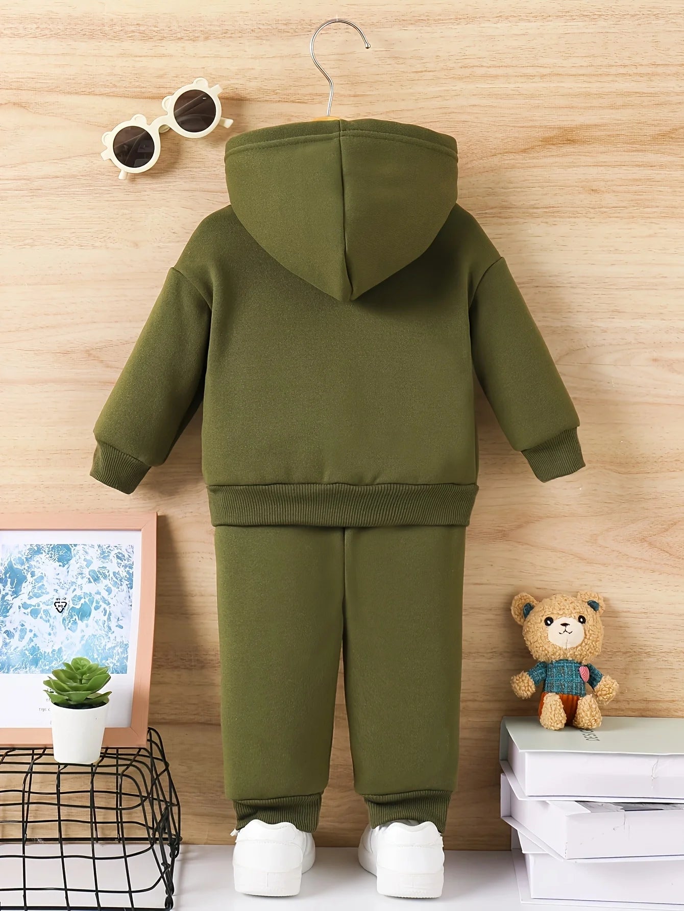 Baby boy wearing a fleece hooded tracksuit with letter print
