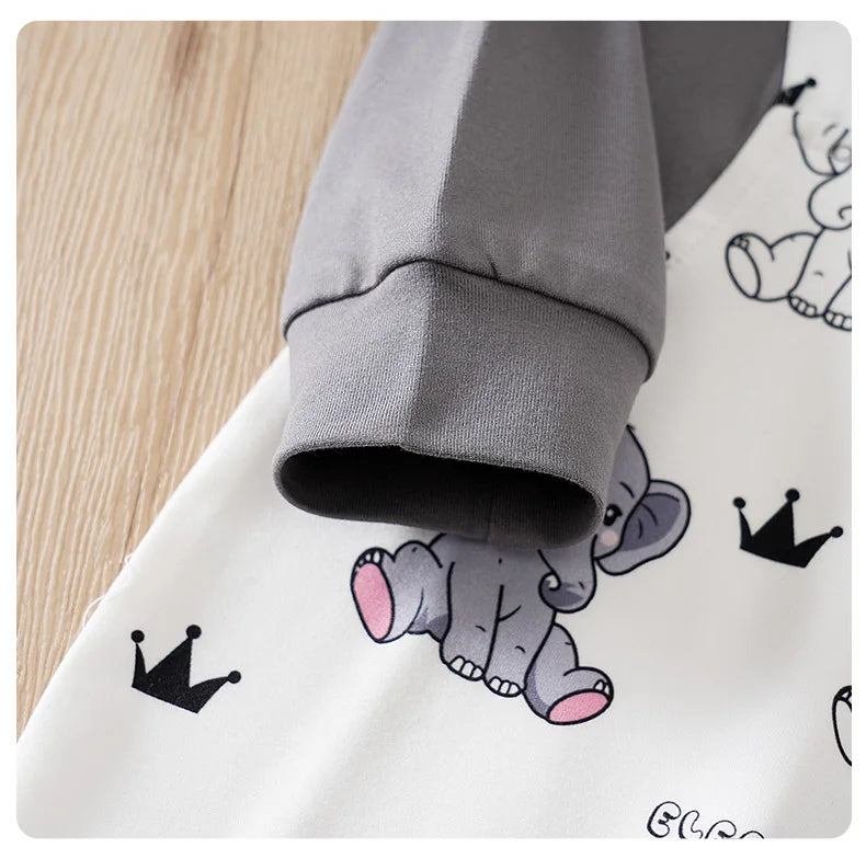 Baby boy wearing a long-sleeve romper with an elephant print and faux braces