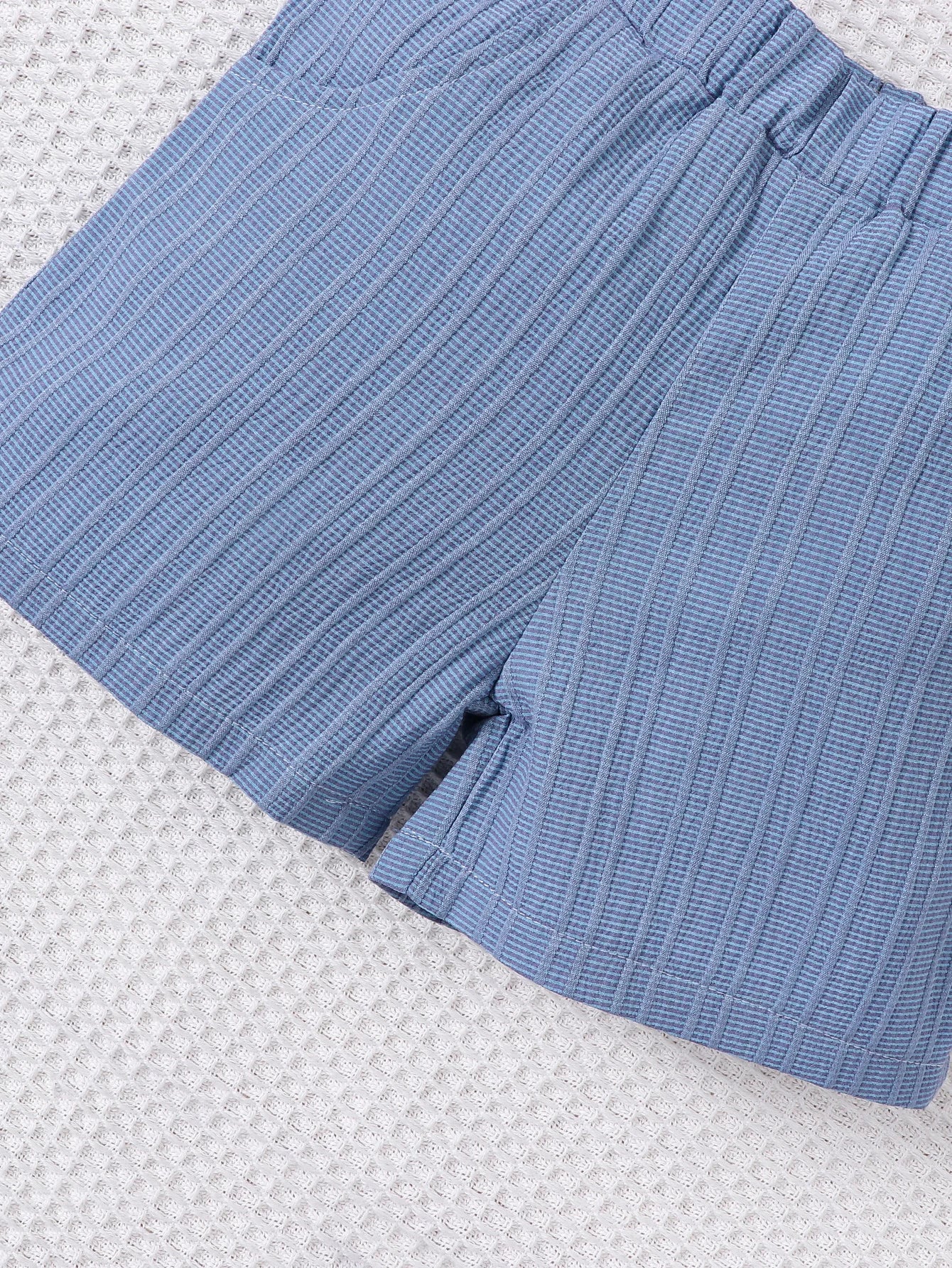 Back or secondary profile shot of the baby boys woven jacquard shirt and shorts set