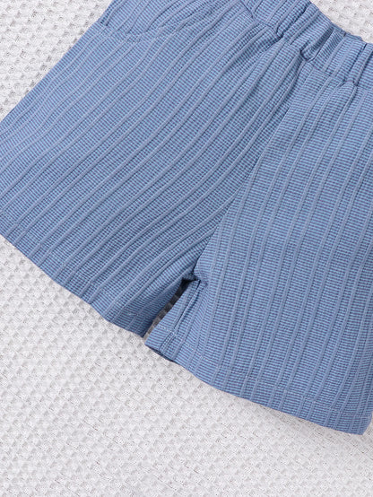 Back or secondary profile shot of the baby boys woven jacquard shirt and shorts set