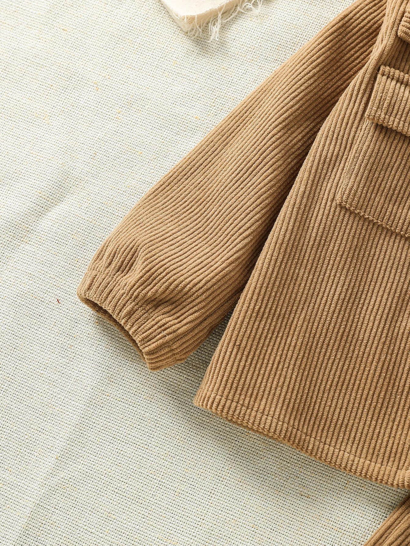 Fabric and texture detail of baby boys stylish jacket & pants outfit