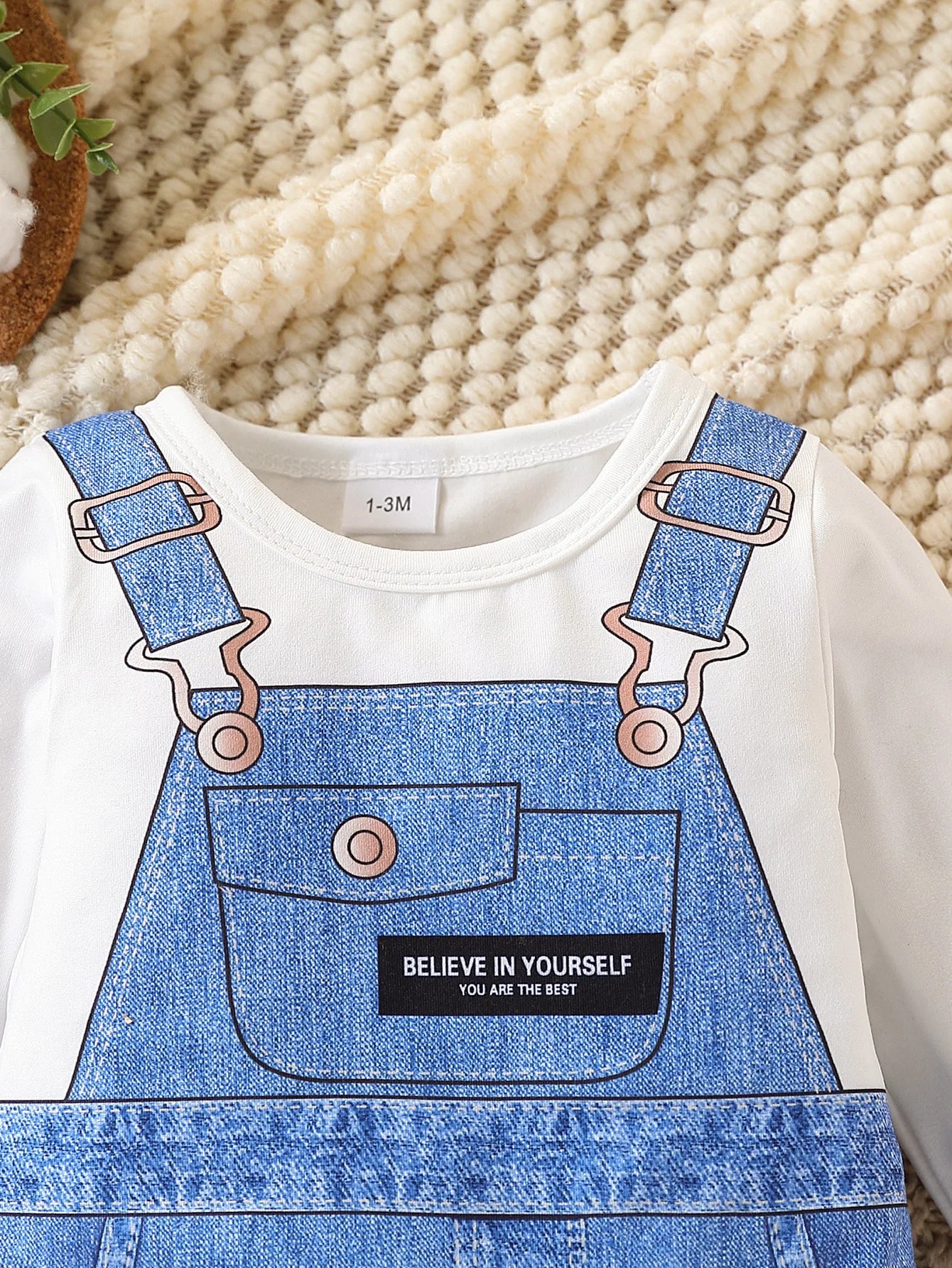 Side or lifestyle view of baby boys faux denim print long sleeve romper