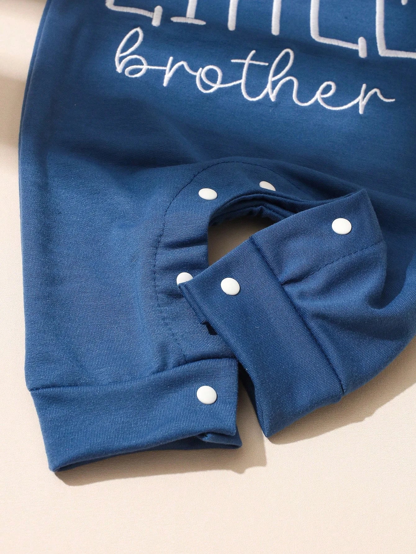 Blue colour version of the newborn boys letter print button bodysuit and hat