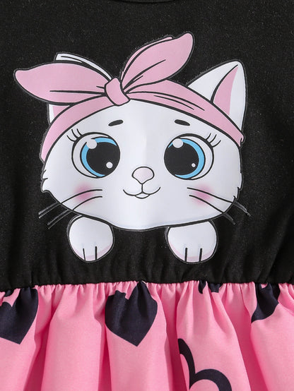 Girl wearing a mid-length dress with a cat and heart print and flutter sleeves