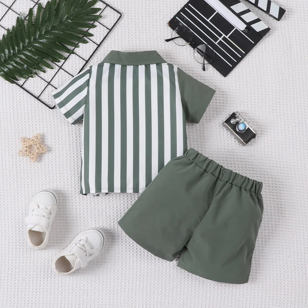 Detail view showing the fabric finish and pattern of the baby boys colour block short sleeve shirt and shorts set