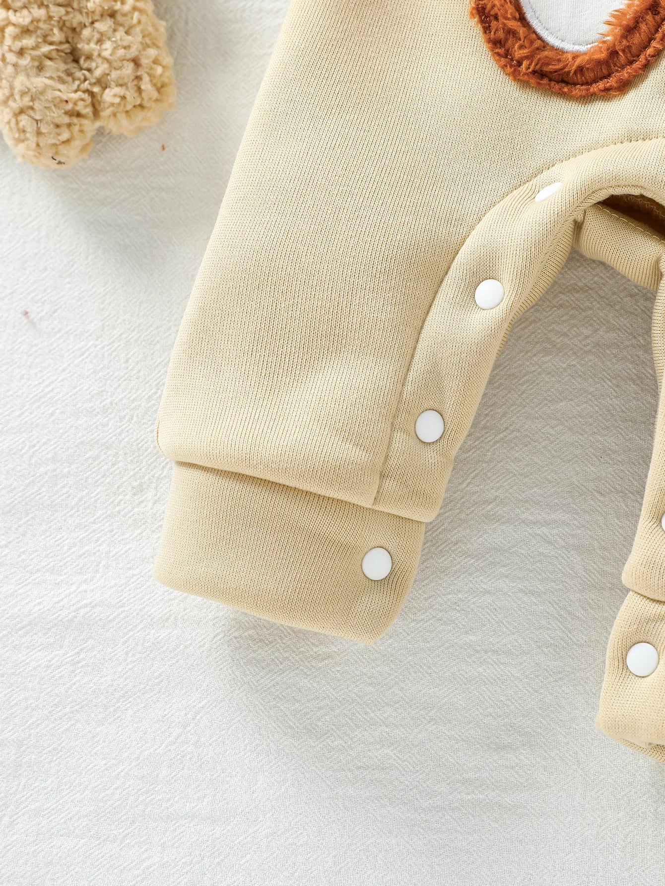 Close up detail of boys striped hoodie & bear overalls set