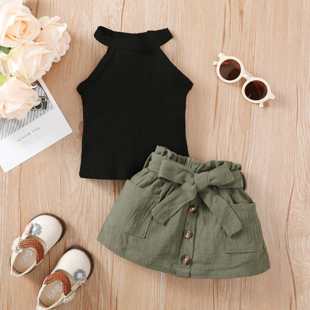Baby girl wearing a ribbed halter top and matching short skirt