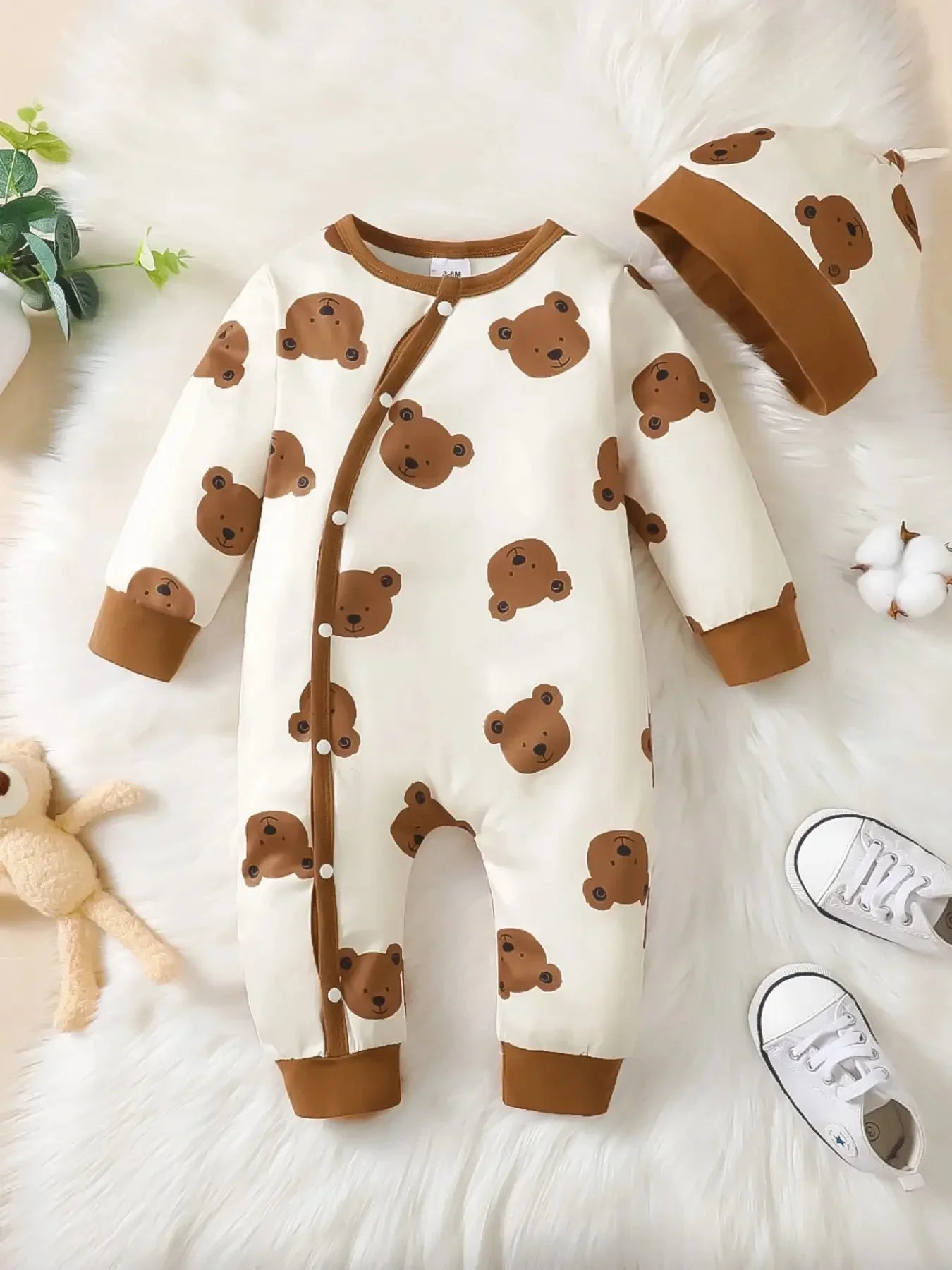 Side or lifestyle view of baby boys bear print button-up winter romper
