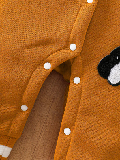 Baby boy wearing a caramel and orange fleece-lined baseball style romper