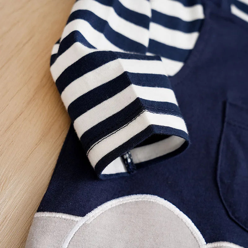 Close up highlighting the hem and stitching on the baby long sleeve striped elephant romper