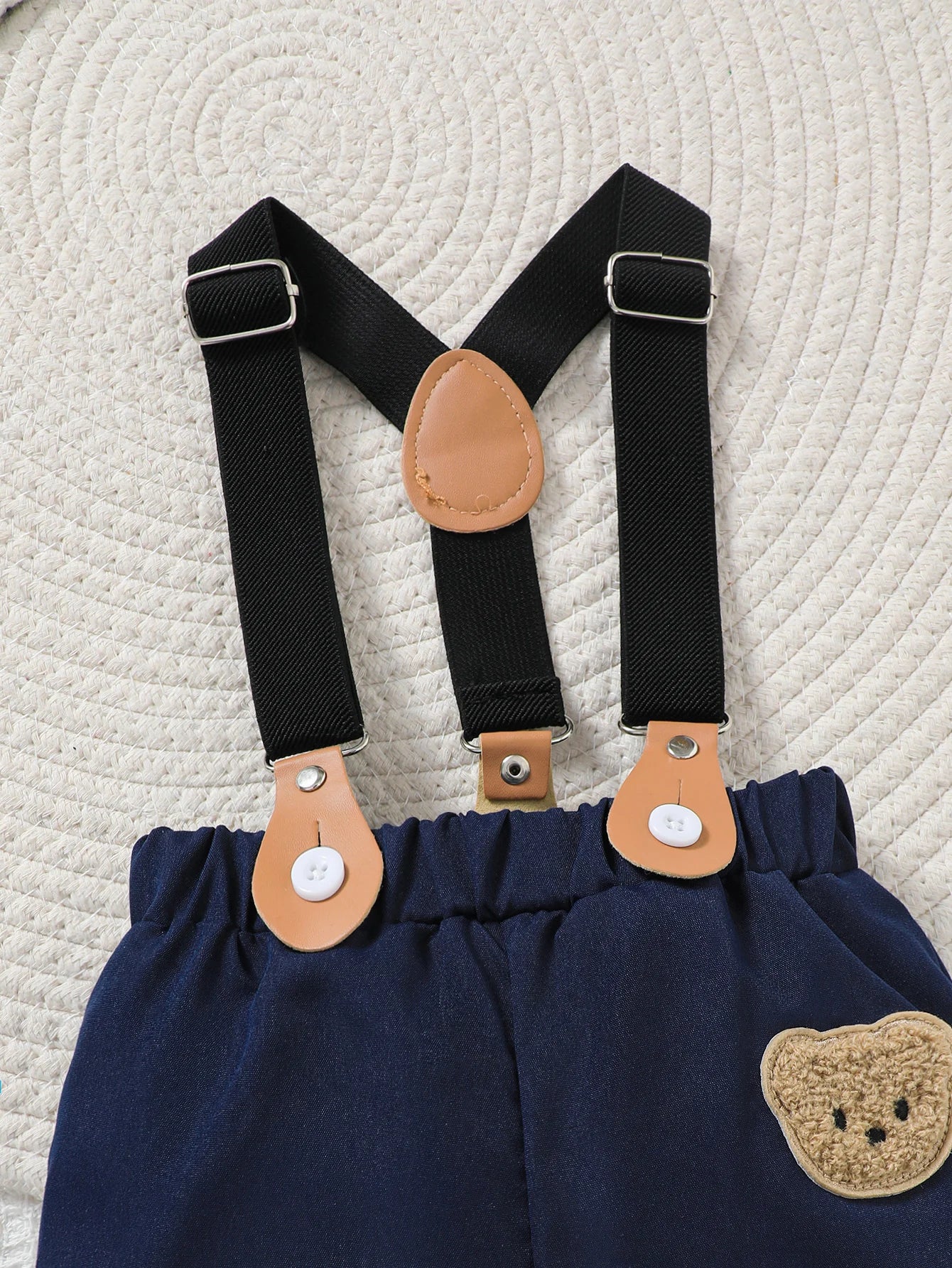 Side or lifestyle view of baby boys striped onesie and bear overalls shorts set