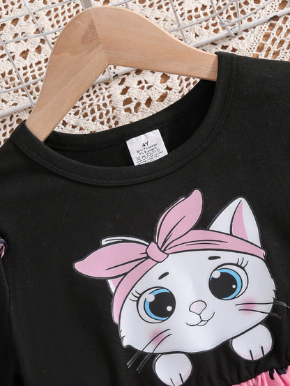 Girl wearing a mid-length dress with a cat and heart print and flutter sleeves
