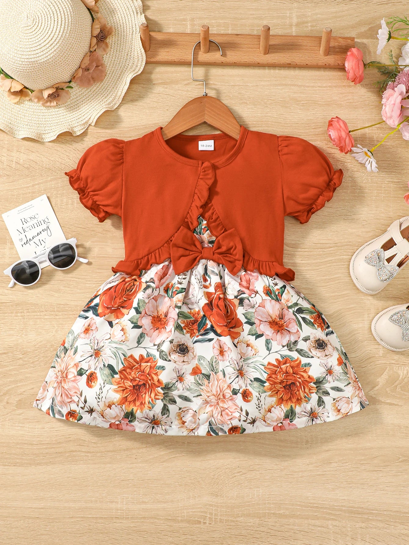 Girl wearing a puff sleeve top and a floral skirt with suspender straps