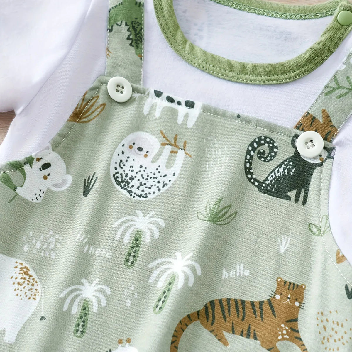 Focus on the neckline and sleeve features of the baby boys zoo animal print short sleeve romper