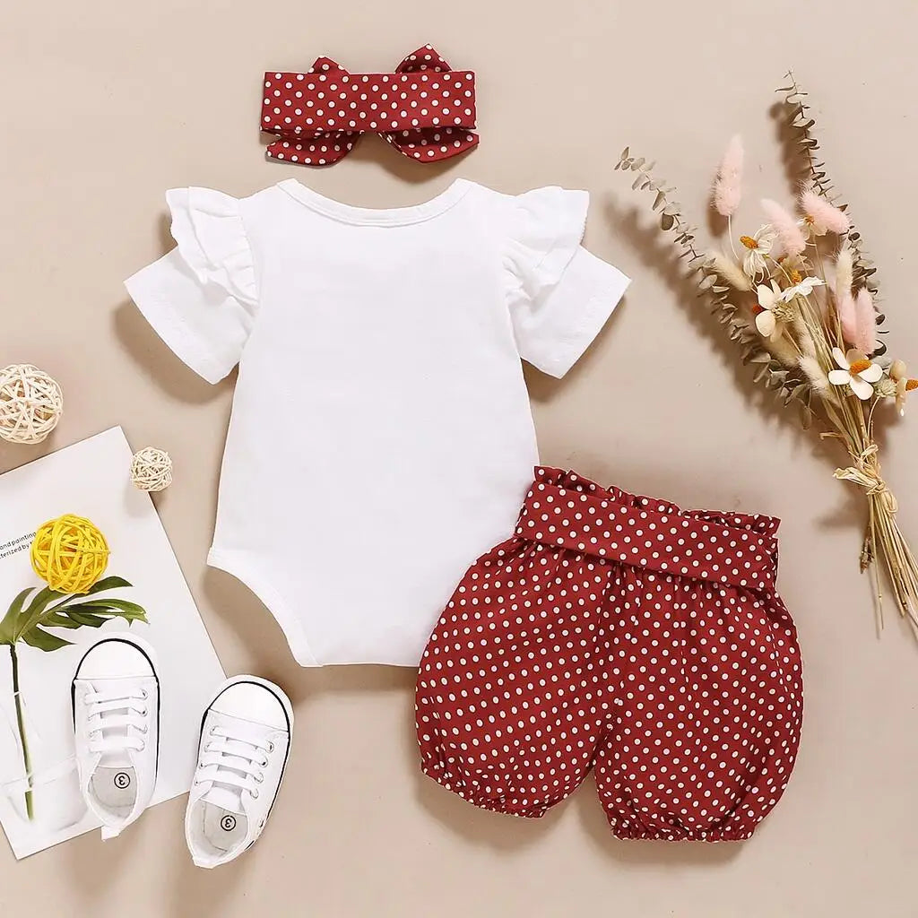 Fabric and texture detail of baby girls romper & polka dot trousers set