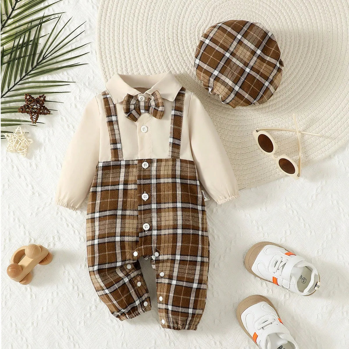 Focus on the neckline and sleeve features of the baby boys gentleman jumpsuit with suspenders and hat