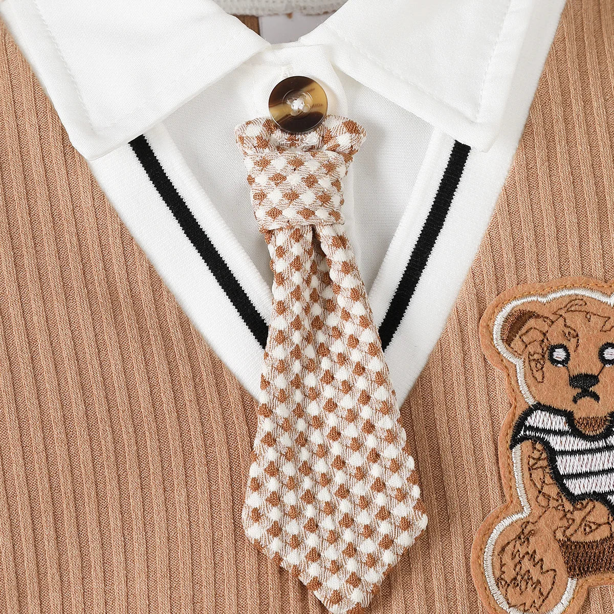 Baby boy wearing a smart short-sleeve romper with an attached tie