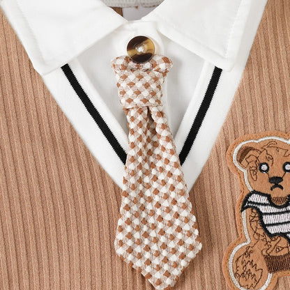 Baby boy wearing a smart short-sleeve romper with an attached tie