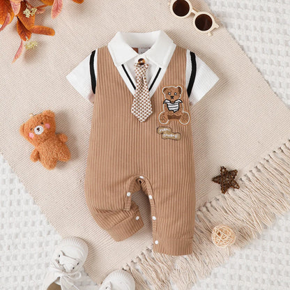 Baby boy wearing a smart short-sleeve romper with an attached tie