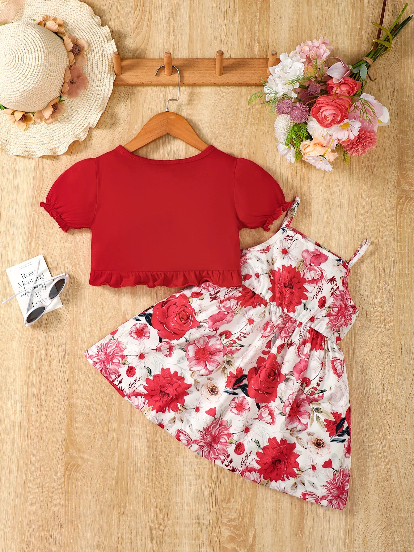 Girl wearing a puff sleeve top and a floral skirt with suspender straps