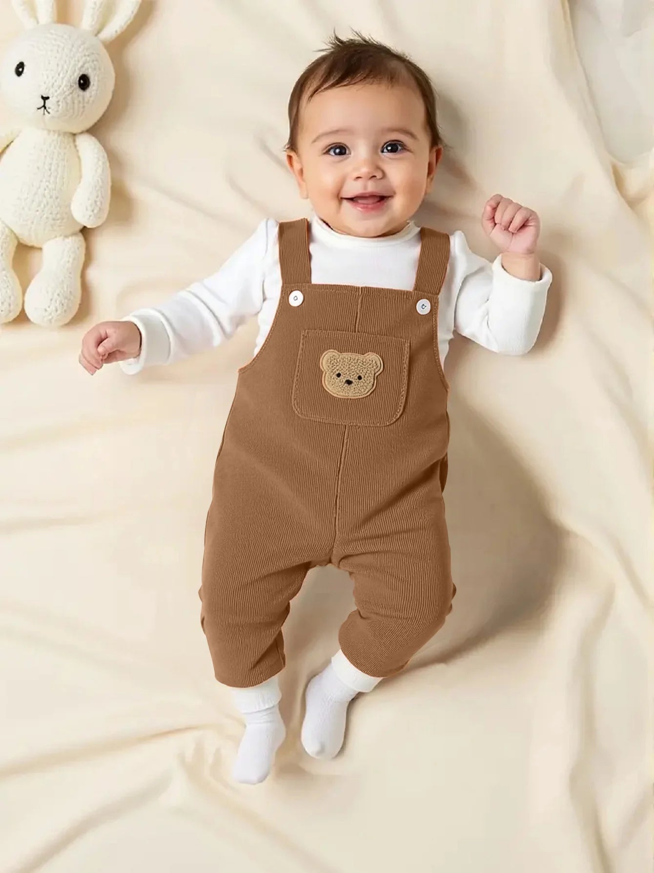 Boys corduroy bib overalls featuring a bear pattern and pocket design