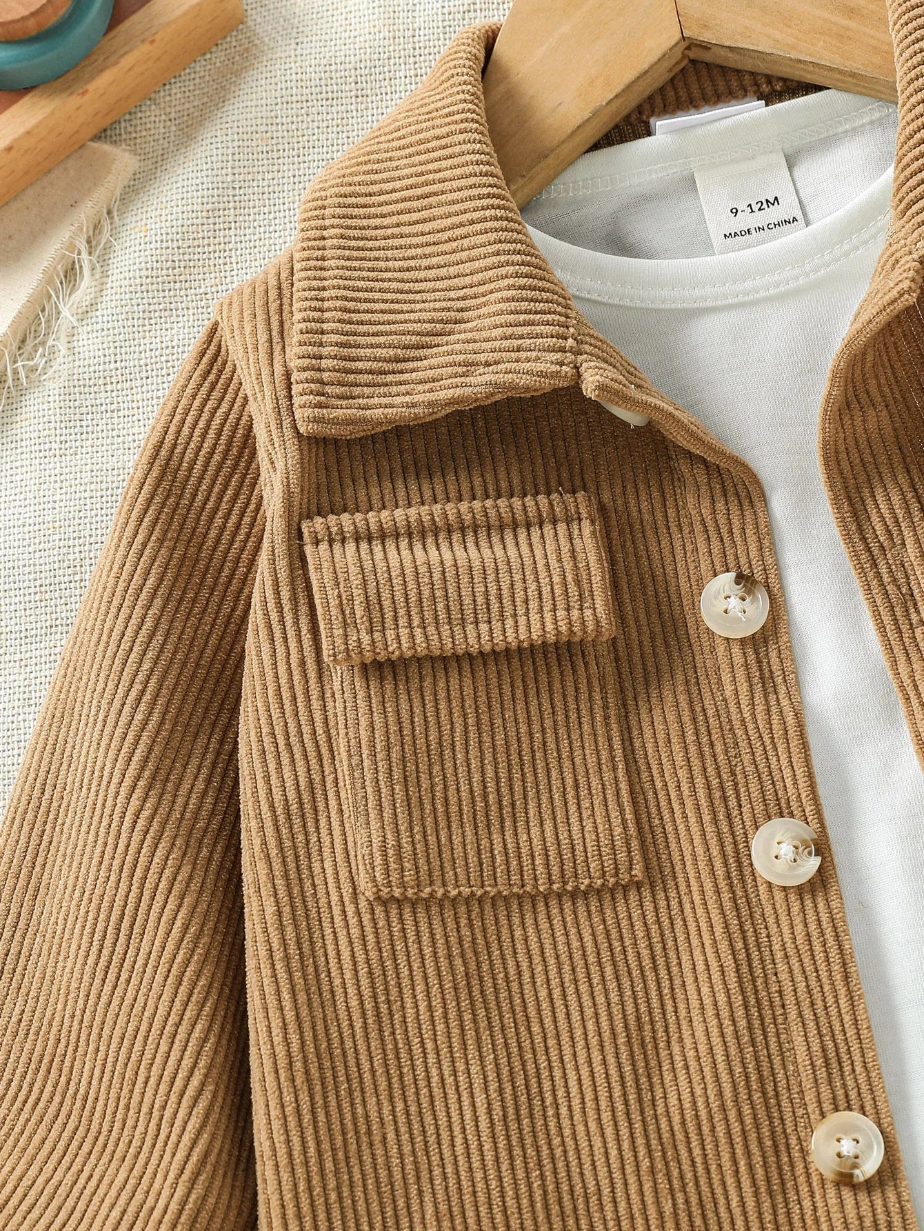 Close up detail of baby boys stylish jacket & pants outfit
