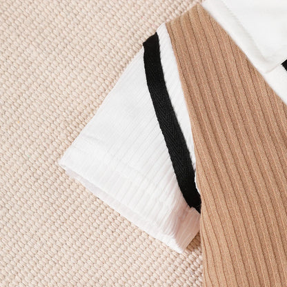 Baby boy wearing a smart short-sleeve romper with an attached tie